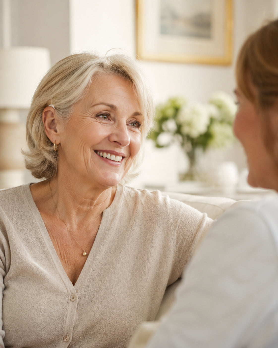 Woman with hearing support enjoying a warm conversation with family